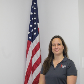 Linsay Windle next to flag